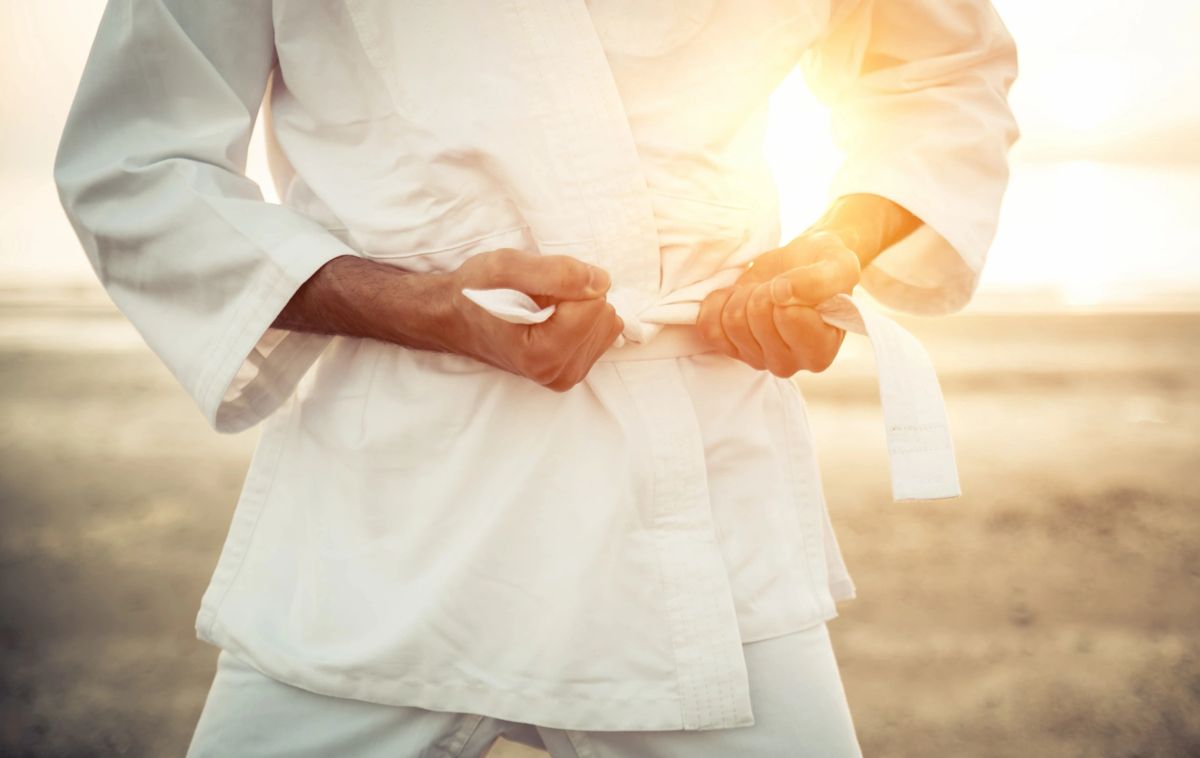 White belt tied over a gi
