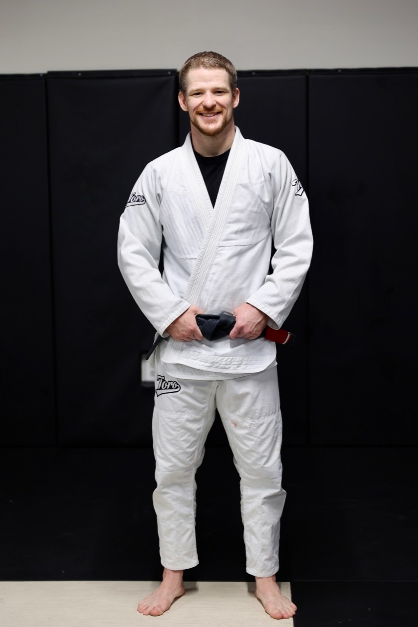 Professor Justin Hale wearing a white gi at Meta Jiu Jitsu Academy